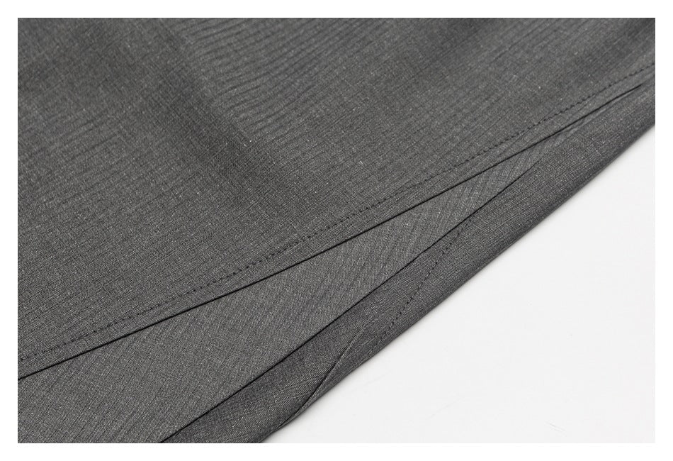 Close-up of dark gray trouser fabric and a neatly stitched hem.