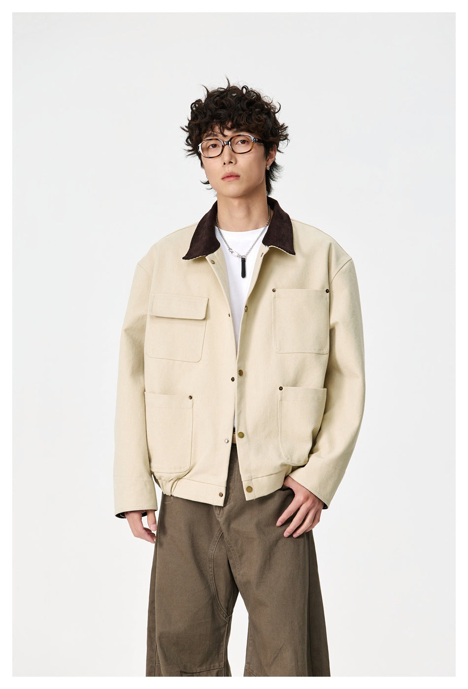 Model wearing a cream jacket with a dark brown collar, snap buttons, and four front pockets.