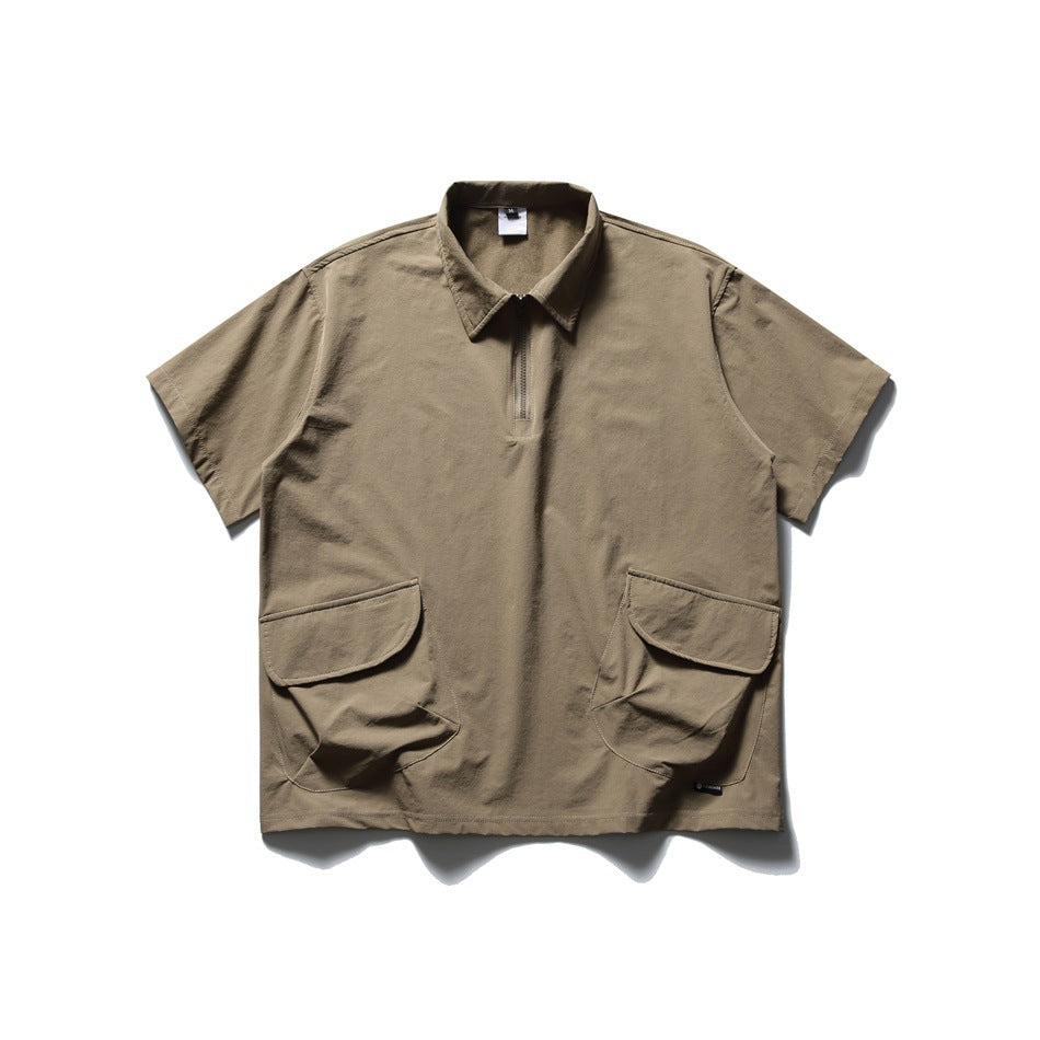 Dark khaki short-sleeve quarter-zip polo shirt with collar and two large flap pockets, laid flat, front view