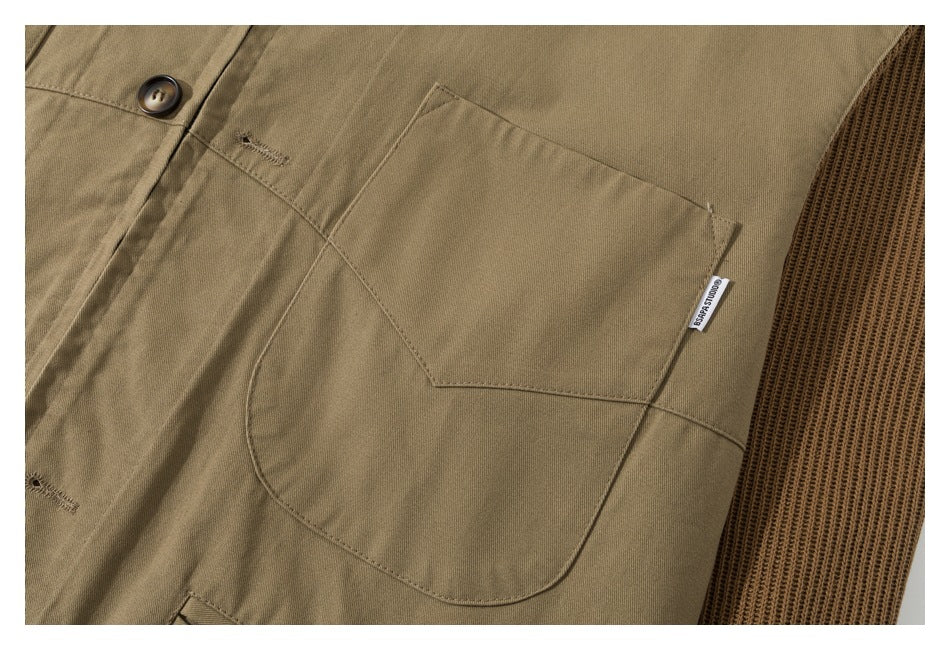 Close-up of a large tan chest pocket beside a brown ribbed knit panel, with a small sewn label.