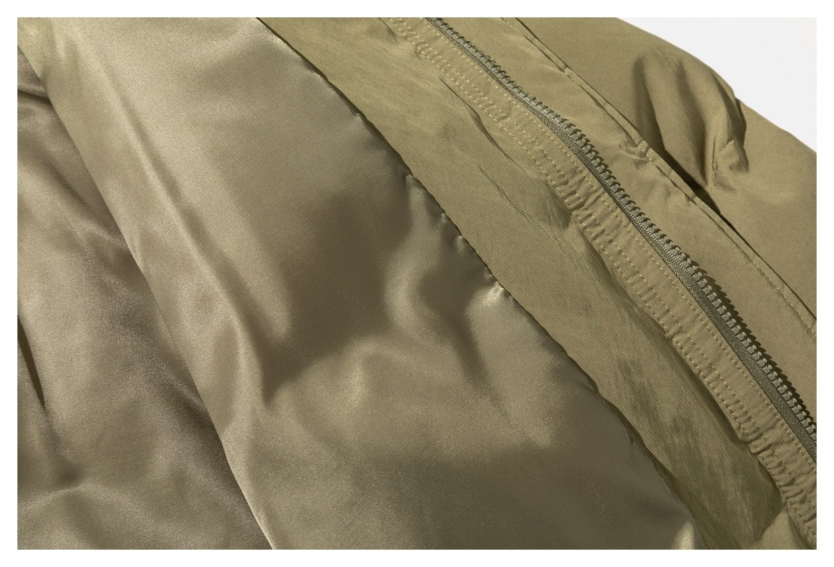 Close-up of the olive-tan jacket's zipper, front placket, and smooth inner lining.