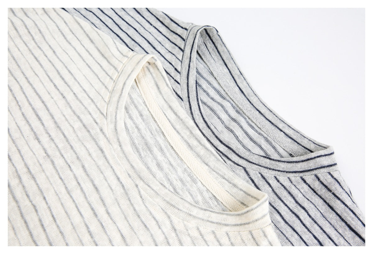 Close-up of cream and gray striped shirts showing their crew necklines and fabric texture.