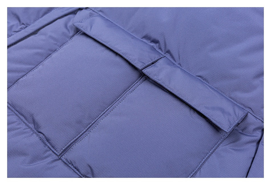 Close-up of a periwinkle garment panel with a wide fabric tab and stitched rectangular section.