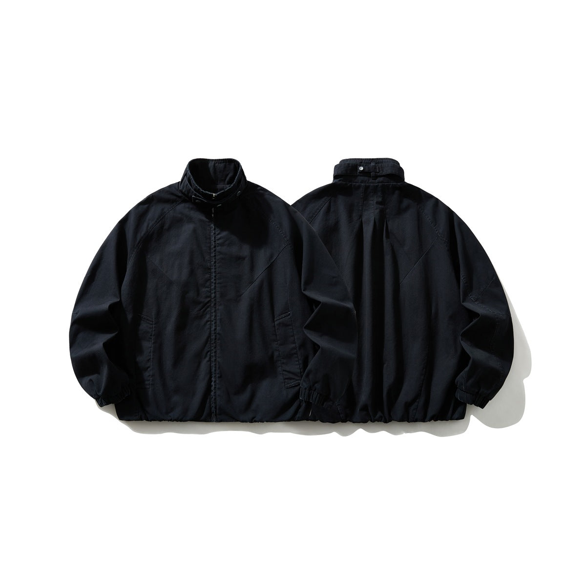 Black jacket shown from the front and back, with a stand collar, raglan sleeves, and gathered cuffs and hem.