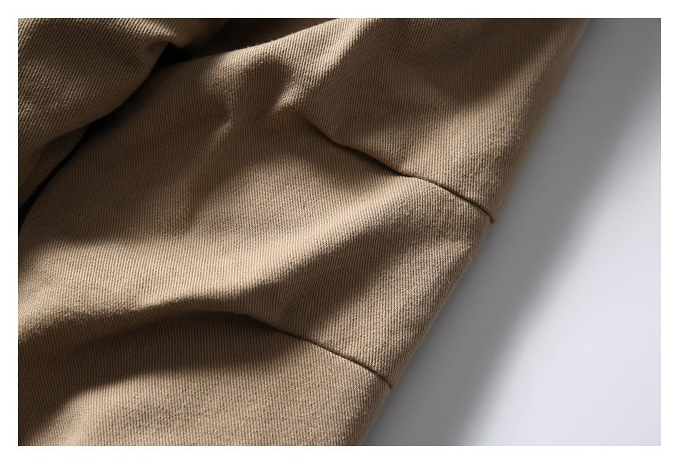 Close-up of tan jacket fabric and curved sleeve seam.