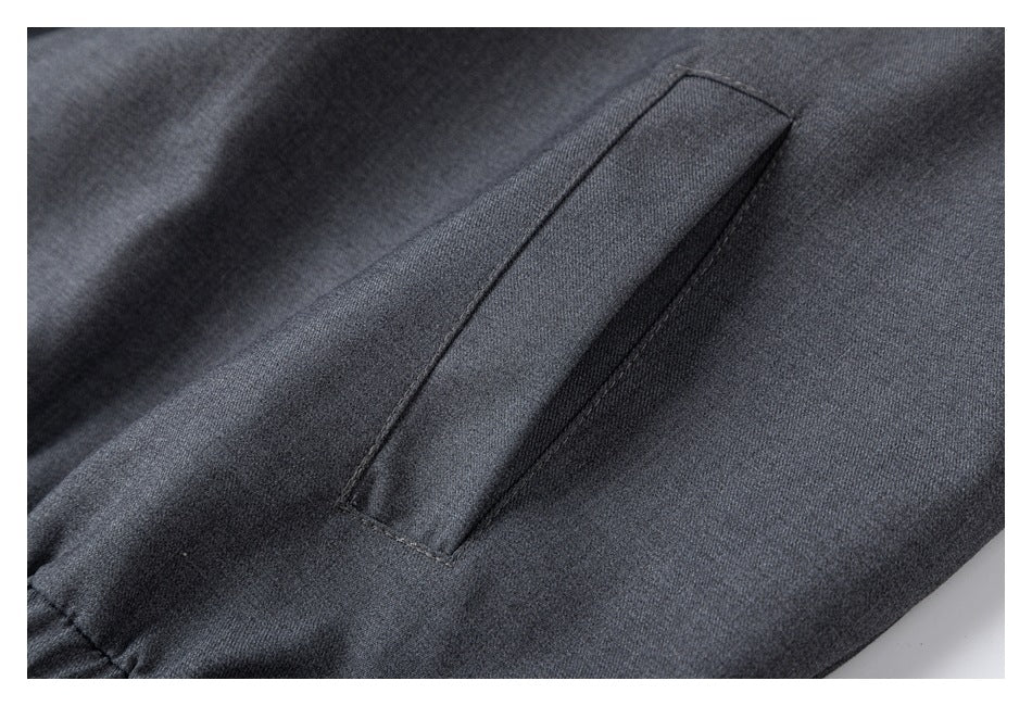 Close-up of a slanted pocket on charcoal gray fabric.