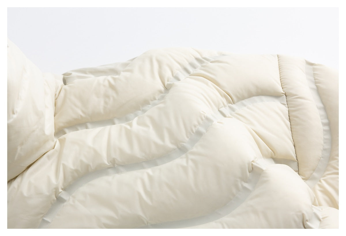 Close-up of the ivory jacket’s quilted padded sections and stitching.