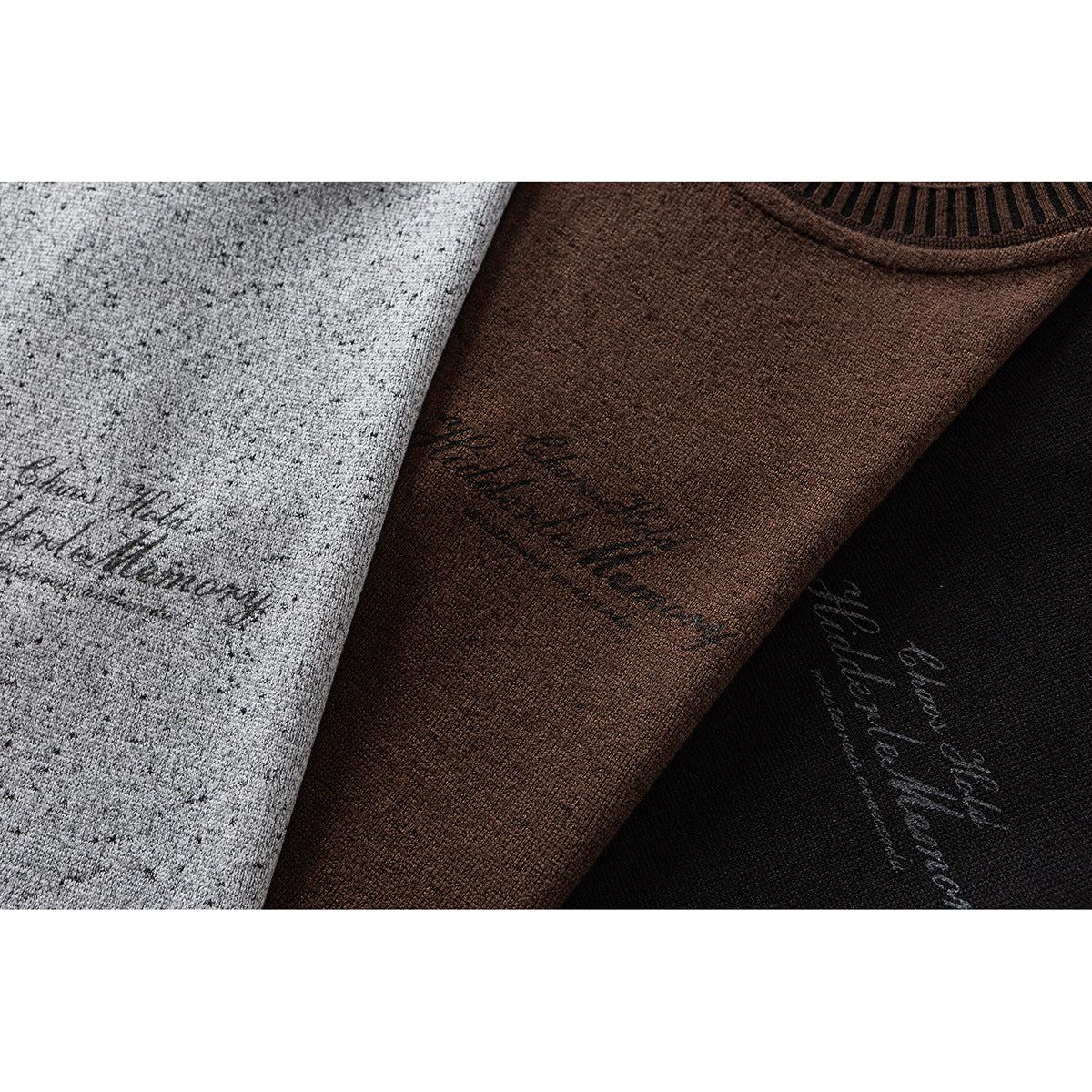 Overlapping gray, brown, and black tops show speckled fabric, striped neck trim, and script chest graphics.