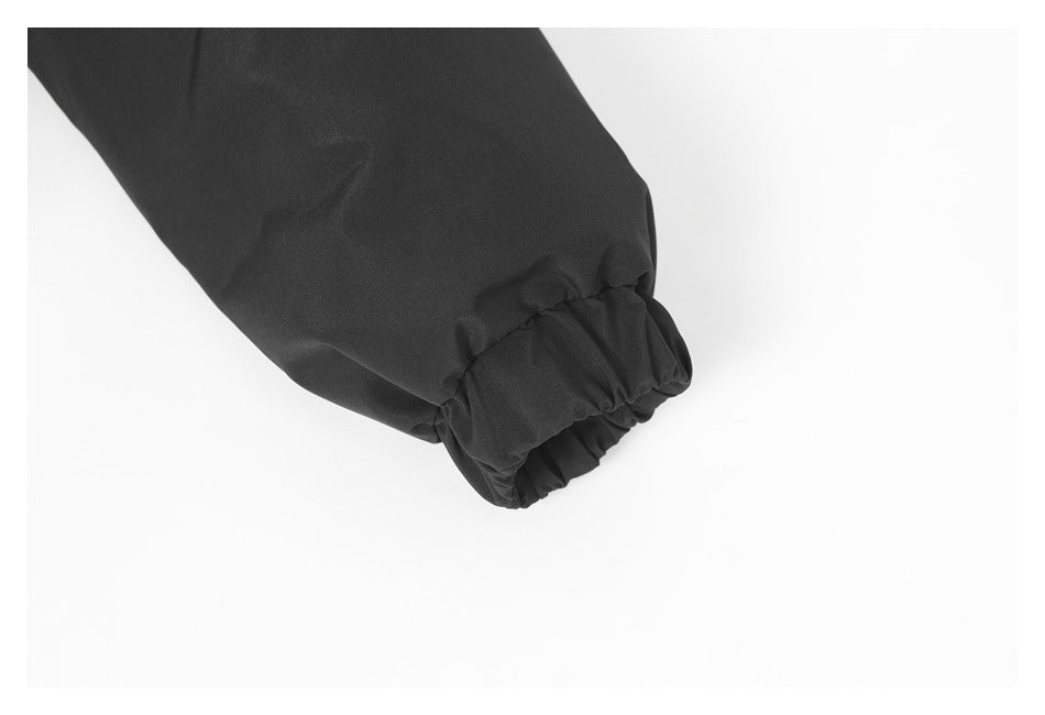 Close-up of a black jacket sleeve ending in a gathered elastic cuff.