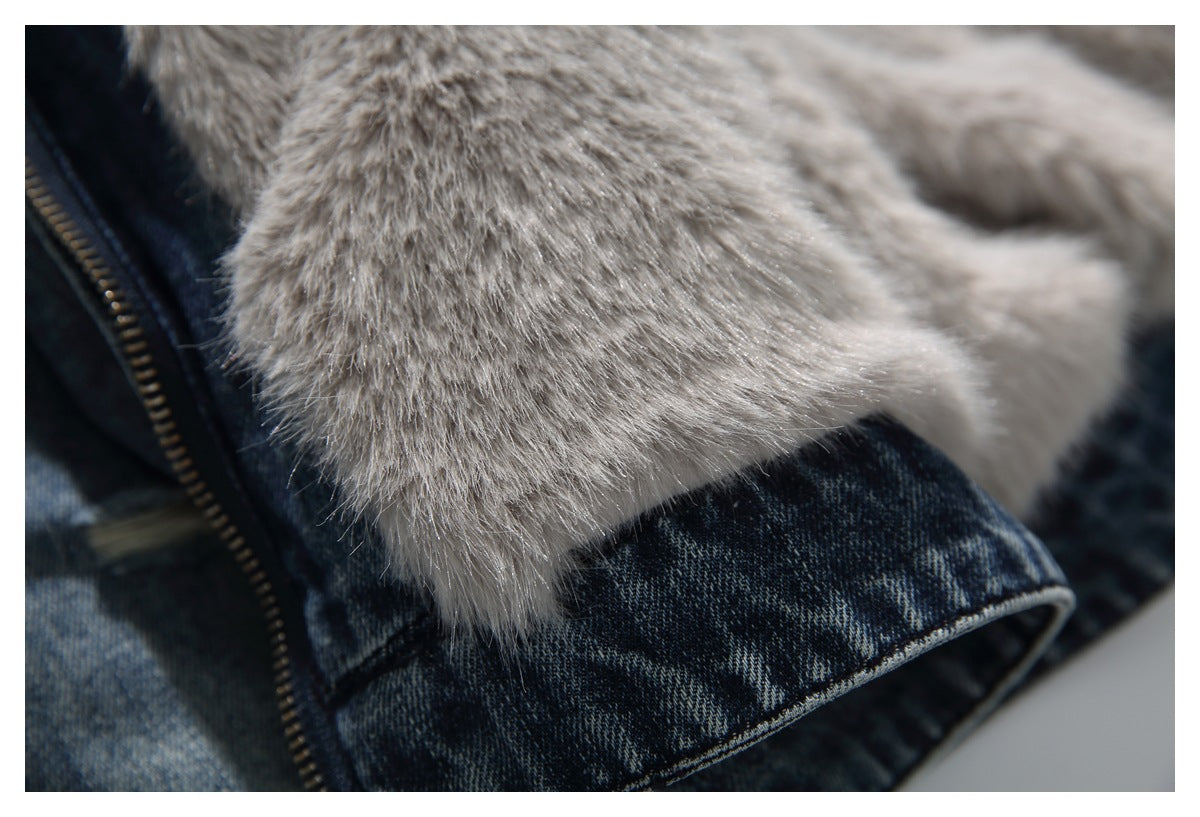Close-up of the light gray plush lining beside the jacket's blue denim zipper edge.