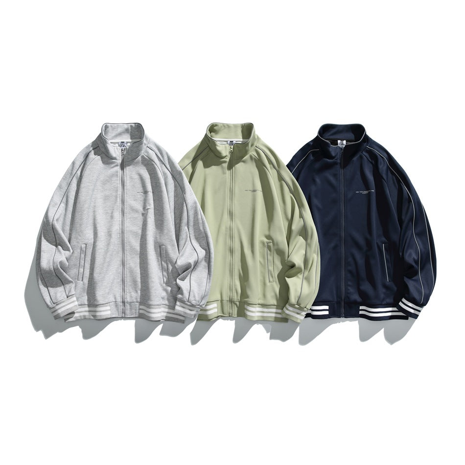 Three front-facing zip jackets displayed together in light gray, pale green, and navy.