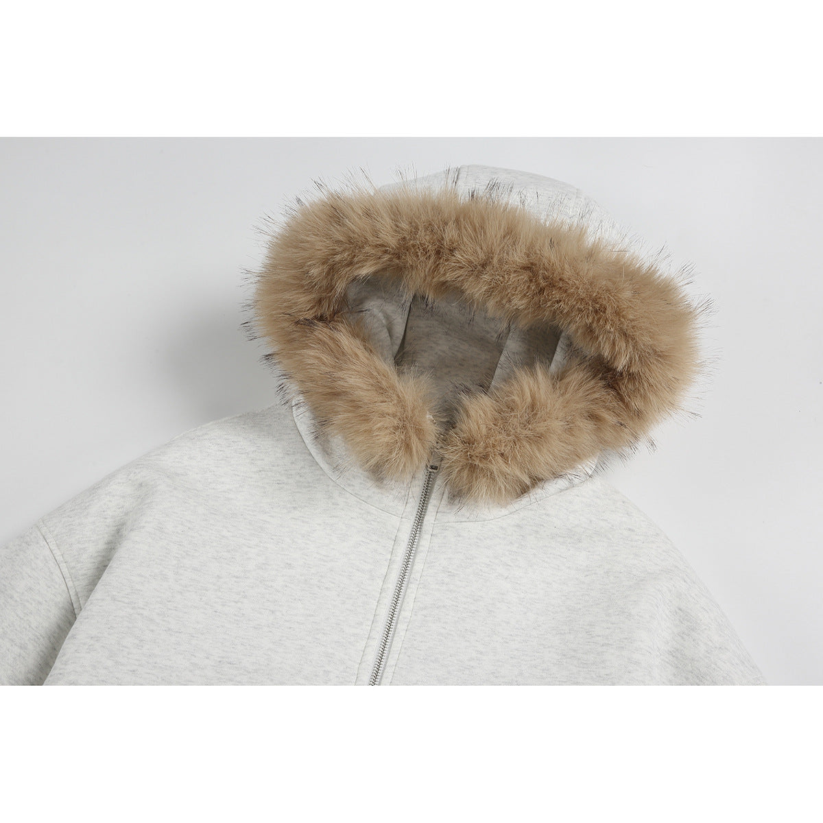 Close-up of a light gray zip-up jacket with a tan fur-trimmed hood.