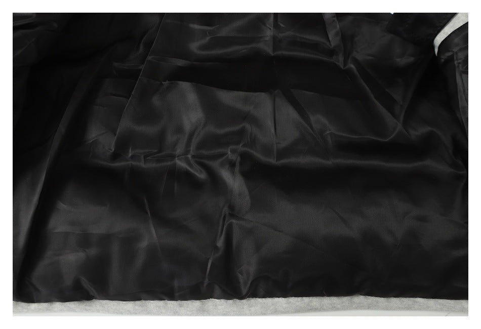 Close-up of the smooth black lining inside a garment, with a light gray edge visible below.