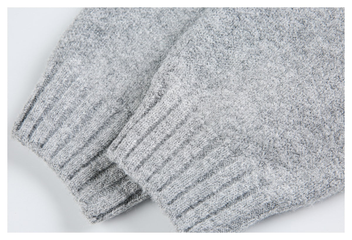 Close-up of light gray knit fabric with overlapping ribbed edges.