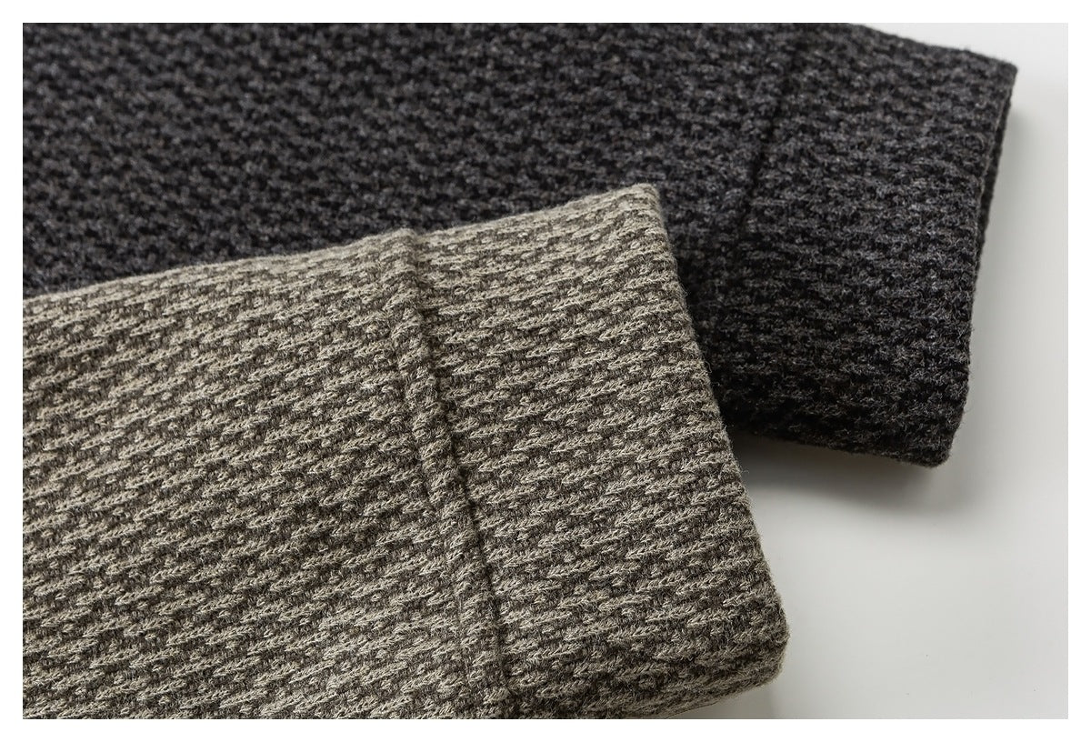 Close-up of overlapping charcoal and gray-brown textured garment cuffs.