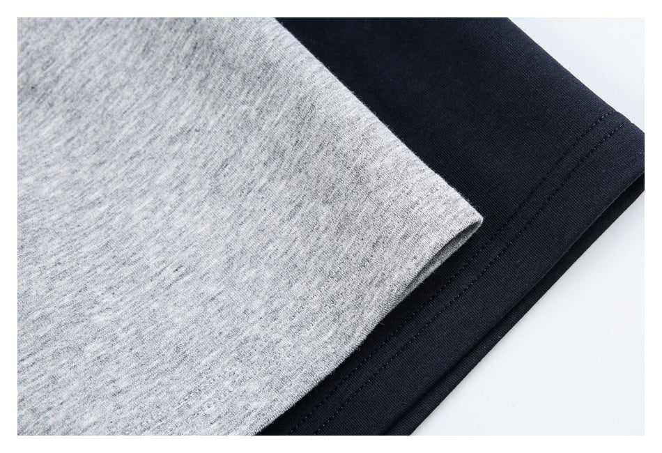 Close-up of heather gray and navy polo shirt fabric with stitched hem edges.