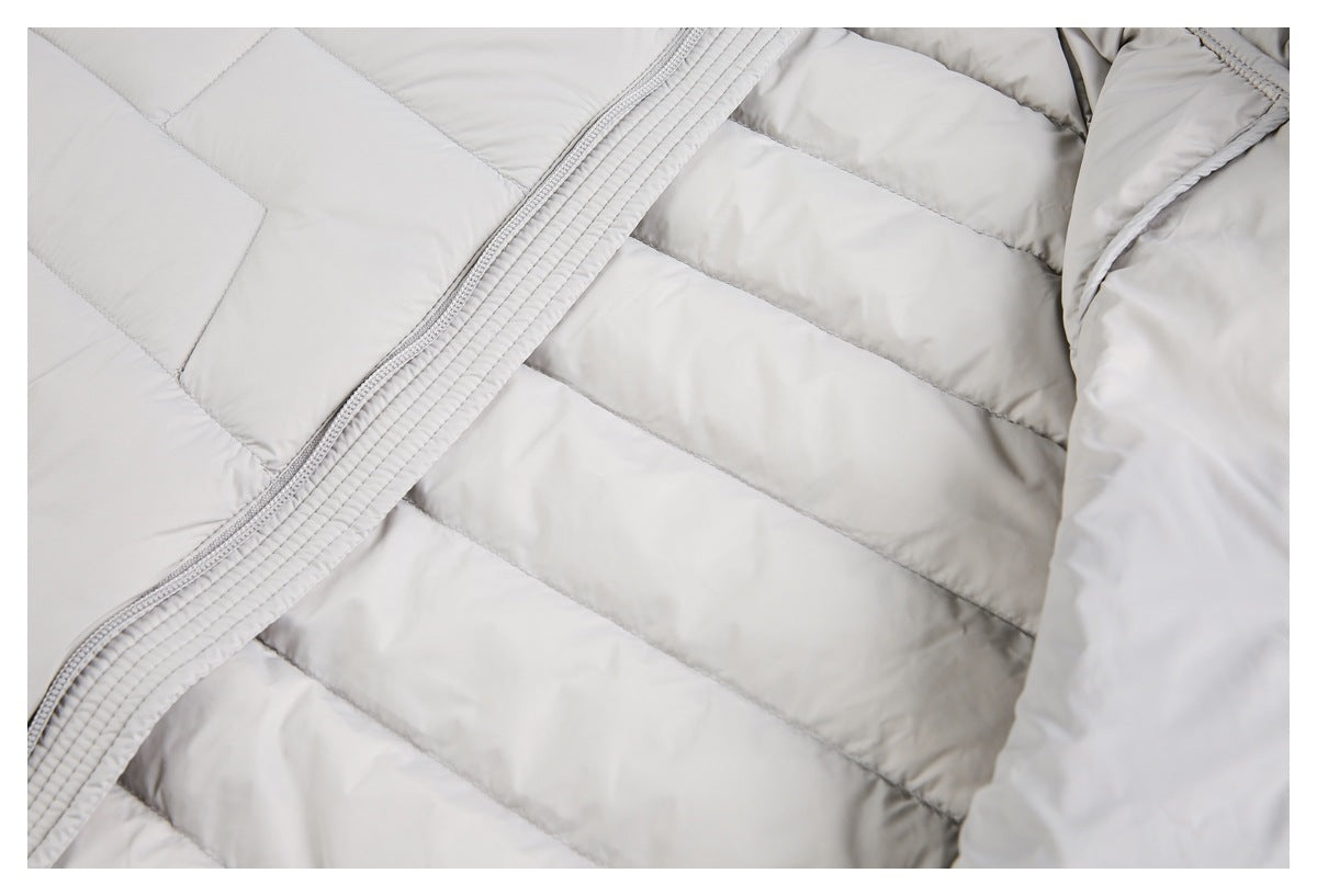 Close-up of the light gray jacket's quilted interior and zipper placket.