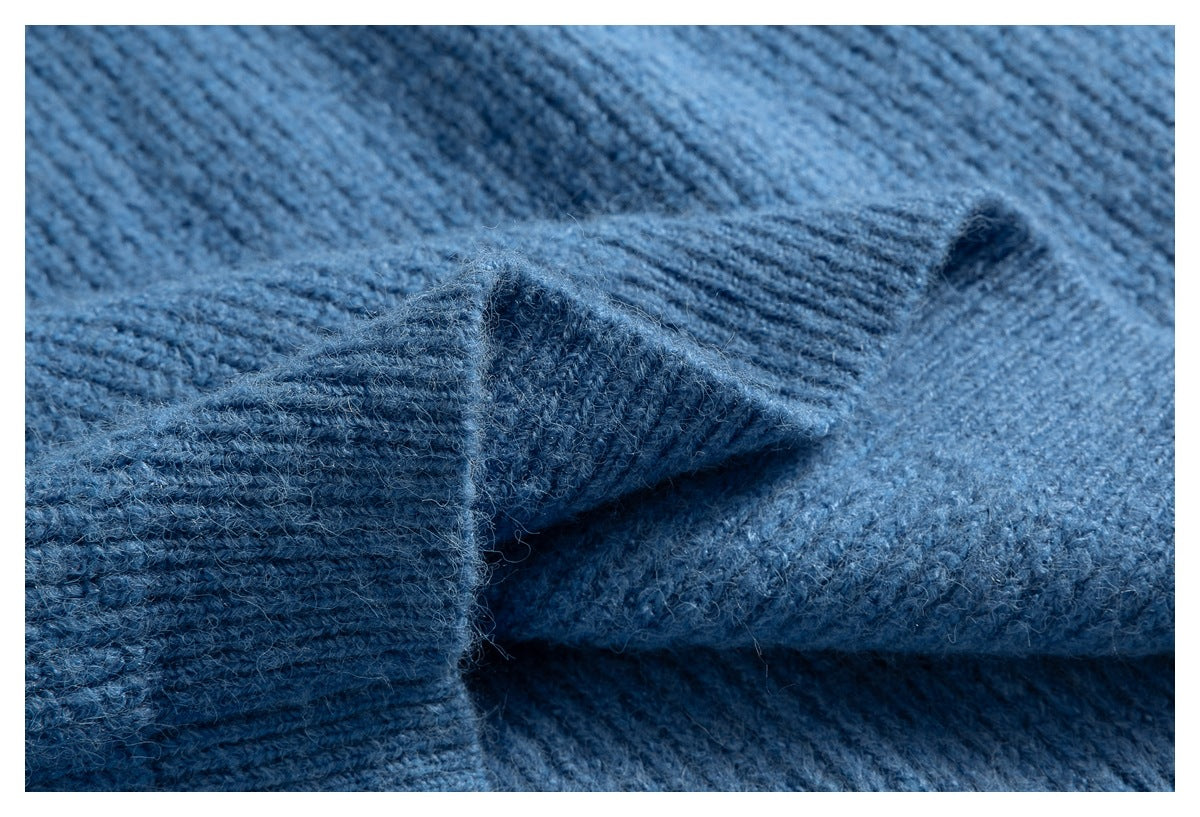 Close-up of a folded ribbed edge on the blue knitted sweater.
