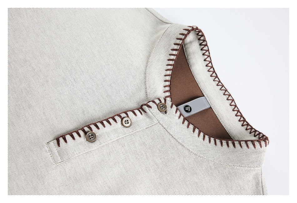 Close-up of an ivory sweatshirt neckline with brown contrast stitching, three buttons, and an XL size tag.