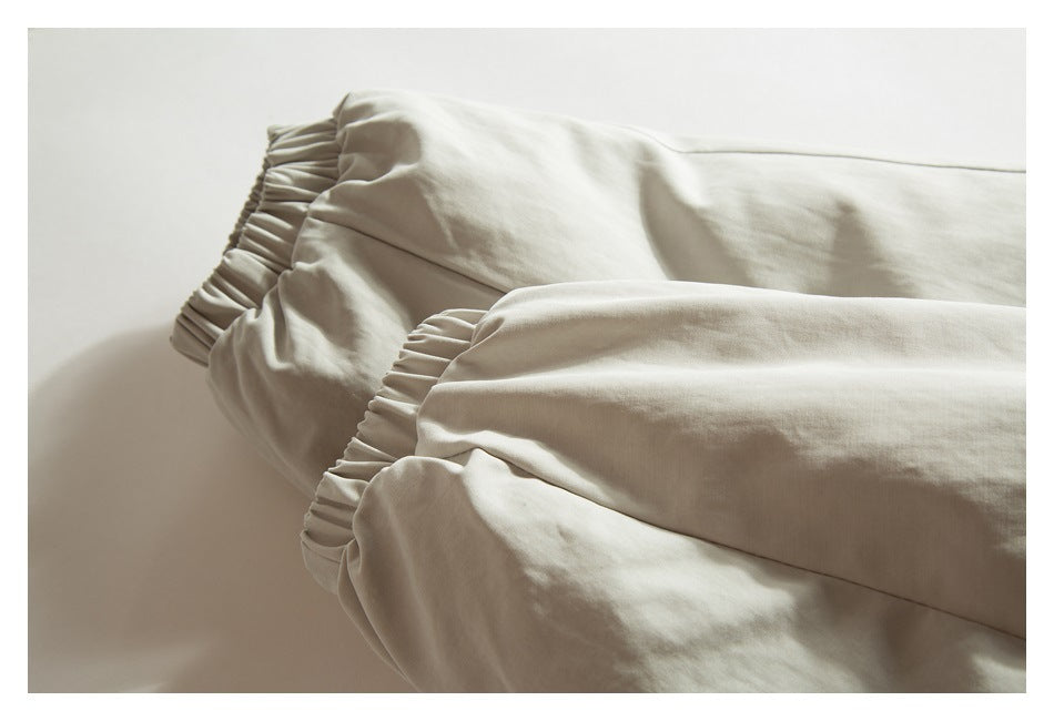 Close-up of the light beige jacket's gathered elastic sleeve cuffs.