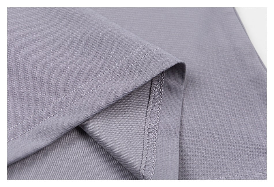Close-up of a lavender-gray garment hem and overlocked seam stitching.