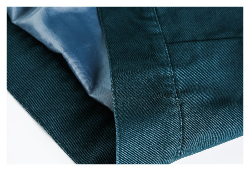 Teal garment opened to show a pale blue lining and stitched inner edge.
