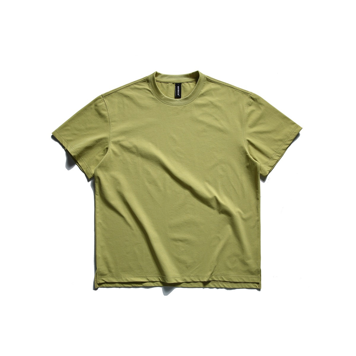 Avocado green short-sleeve crew neck T-shirt laid flat, front view, with side hem slits