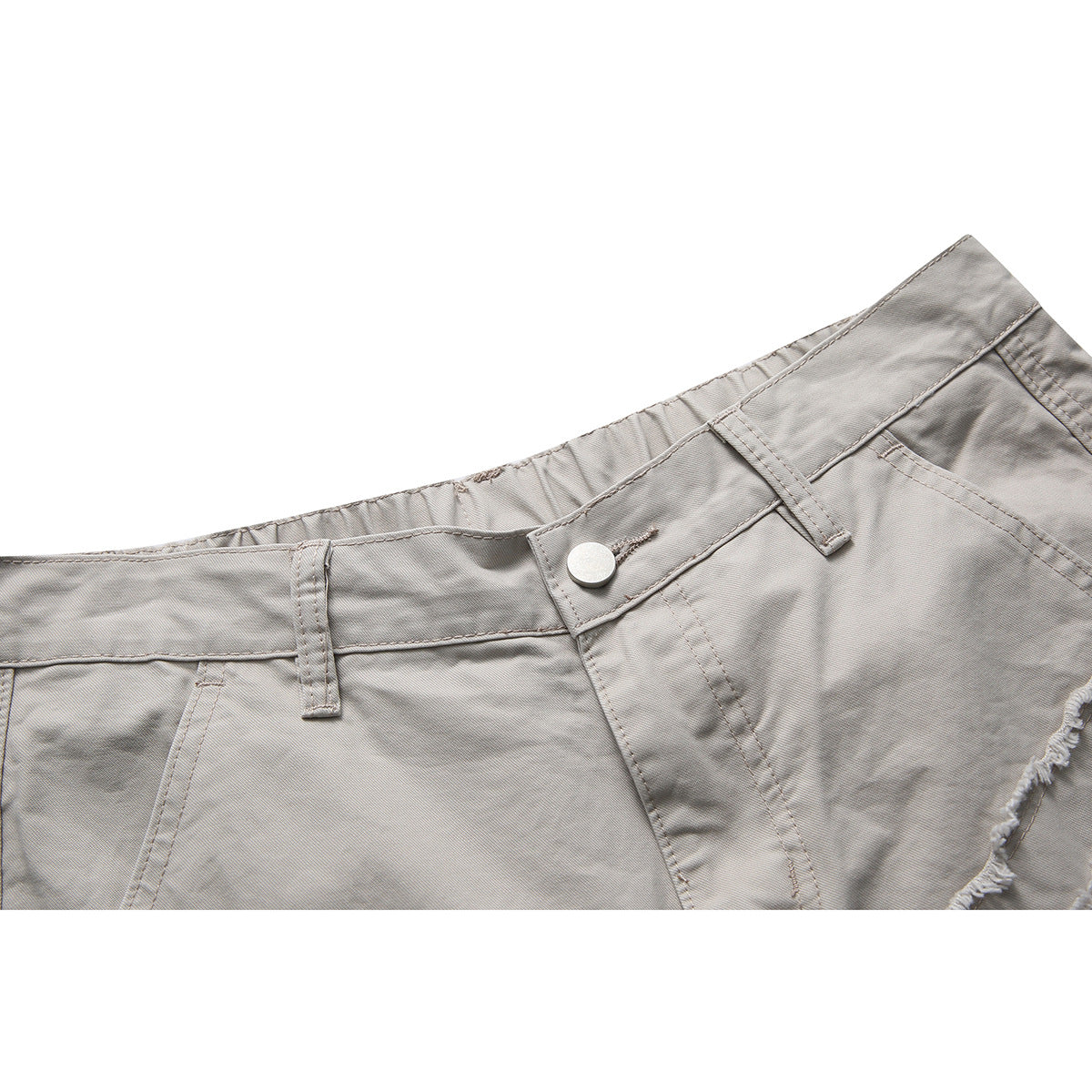 Close-up of light gray shorts' waistband, button, belt loops, and front pocket edge.