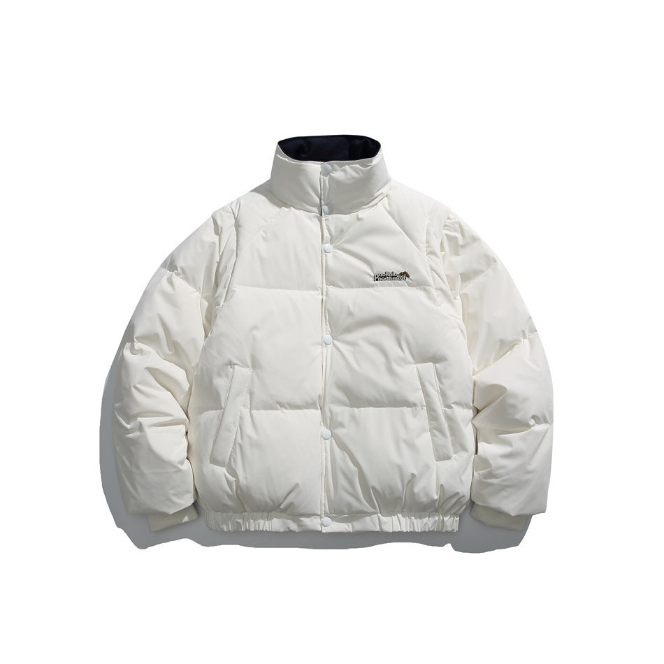 White puffer jacket with stand collar, snap front, front pockets, elastic hem and small chest logo, flat lay