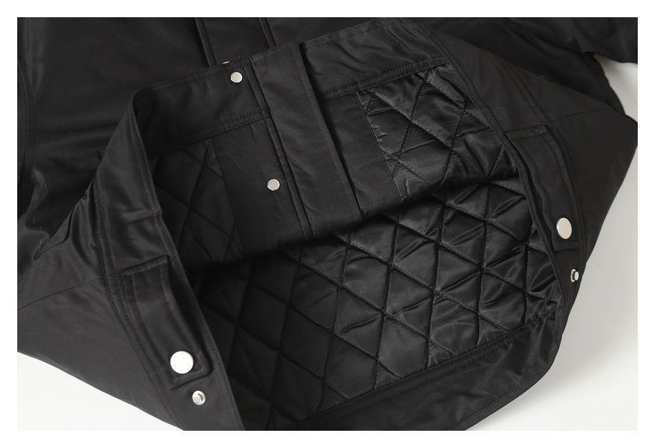 Black jacket opened to show its diamond-quilted lining and inner snap fasteners.