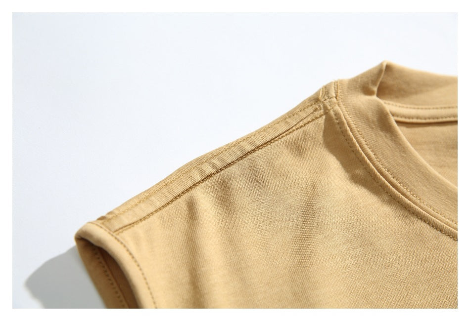 Close-up of the shirt's shoulder seam, armhole binding, and crew-neck stitching.