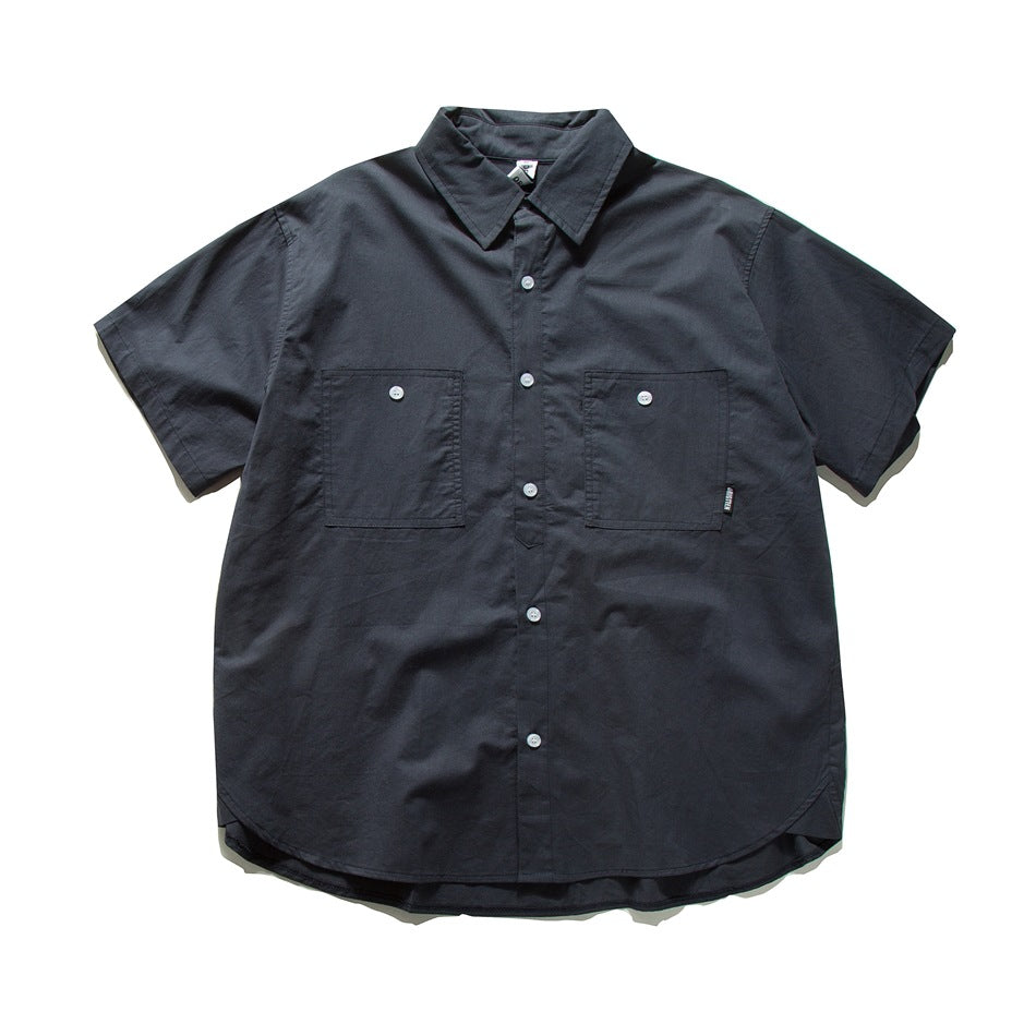 Navy short-sleeve button-front shirt with two chest patch pockets and a curved hem, laid flat