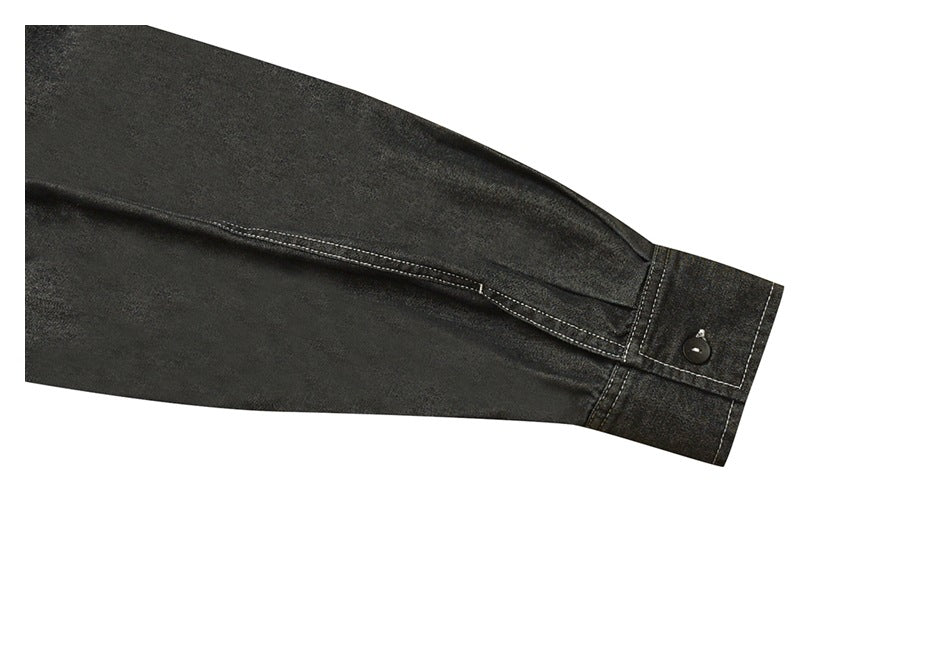 Close-up of a dark charcoal sleeve ending in a buttoned cuff with visible stitching.