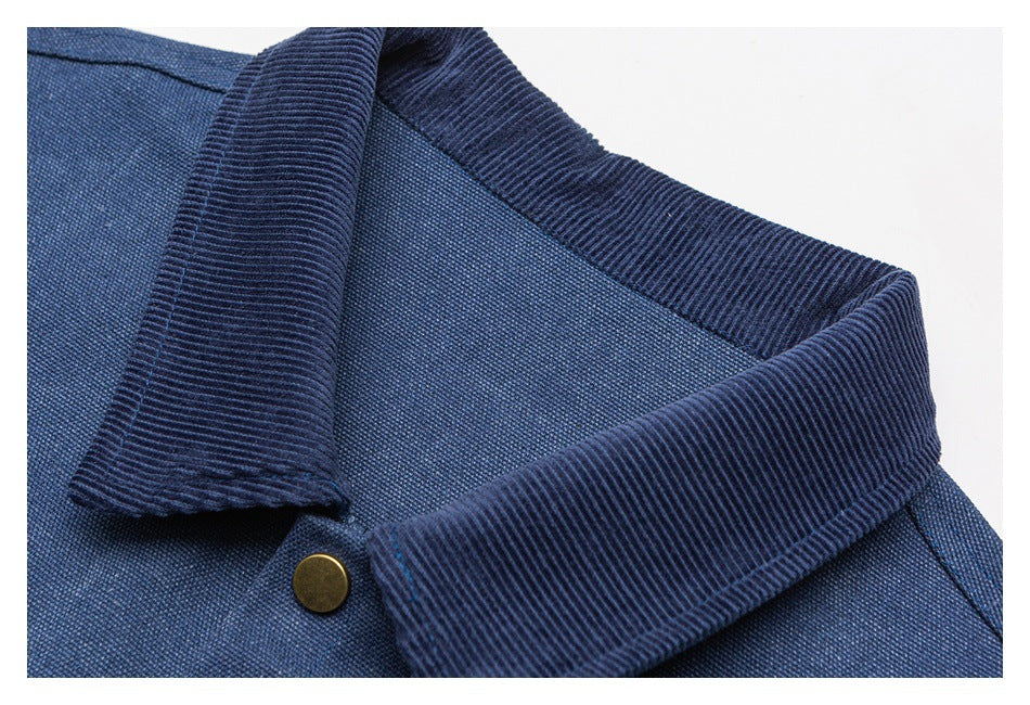 Close-up of the jacket's dark ribbed collar and a brass-tone button.