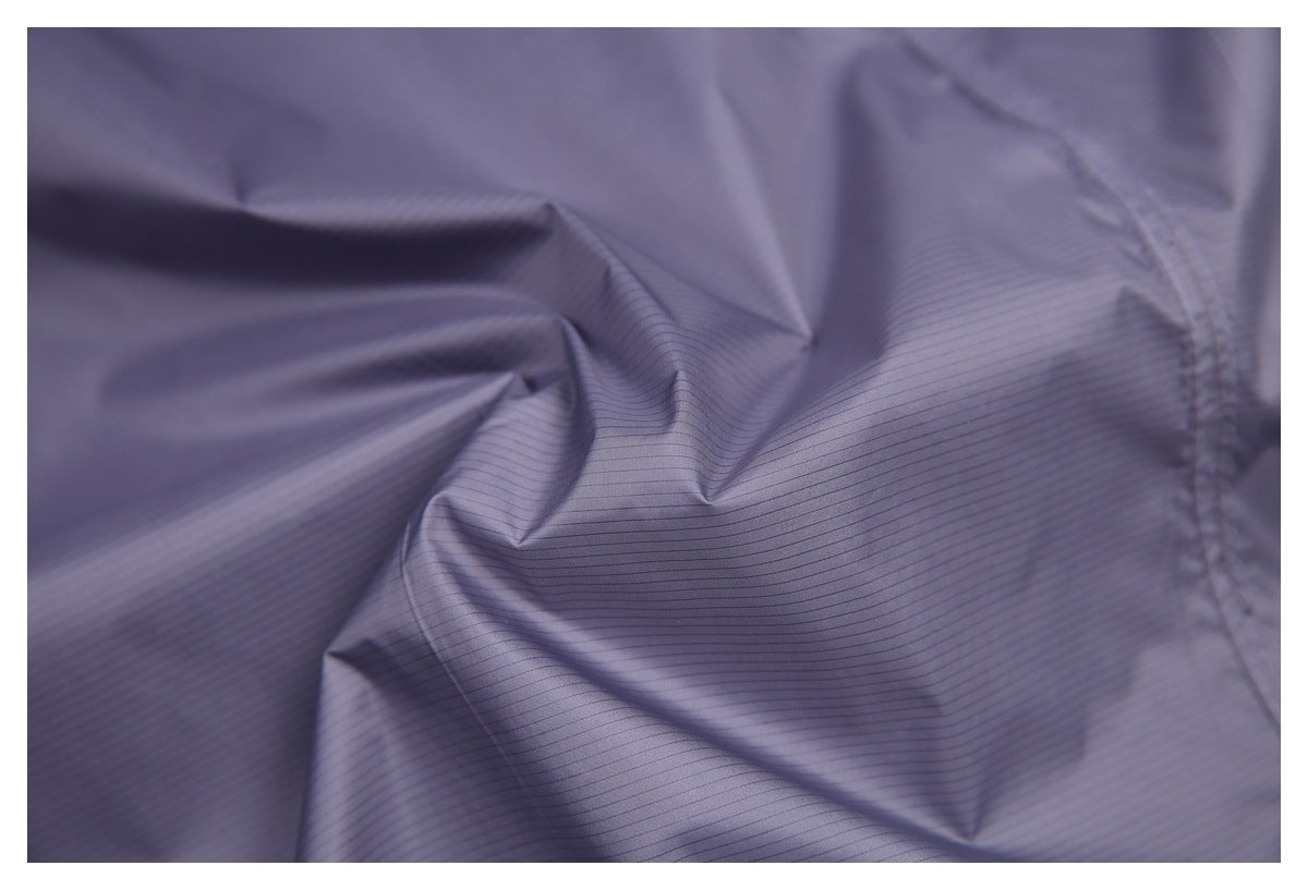 Close-up of the jacket's grayish lavender outer fabric, showing fine stripes and stitched seams.