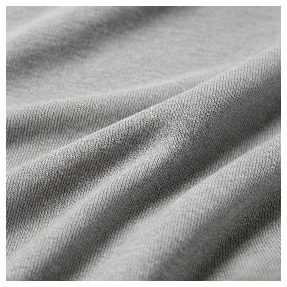 Close-up showing the fine ribbed texture and folds of gray knit fabric.