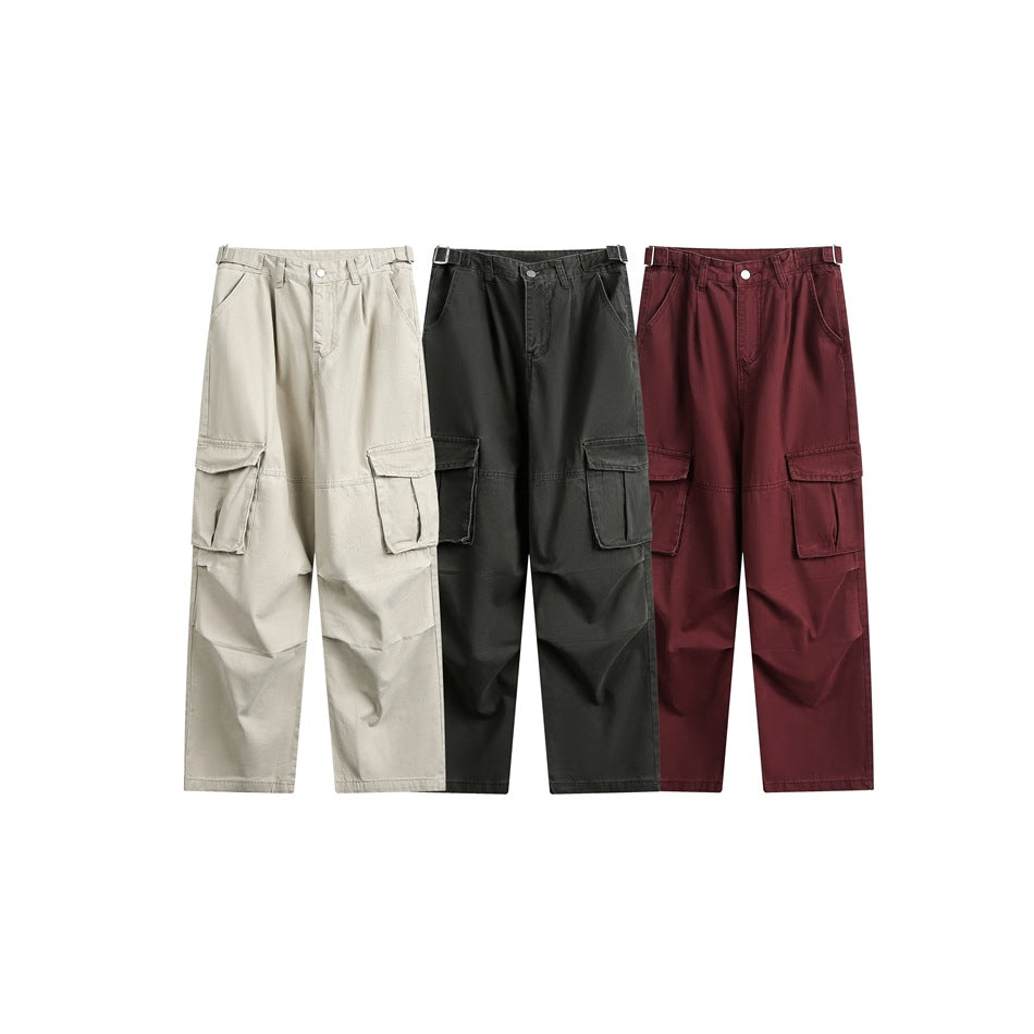 Front view of wide-leg cargo pants in beige, charcoal, and burgundy, each with large side pockets.