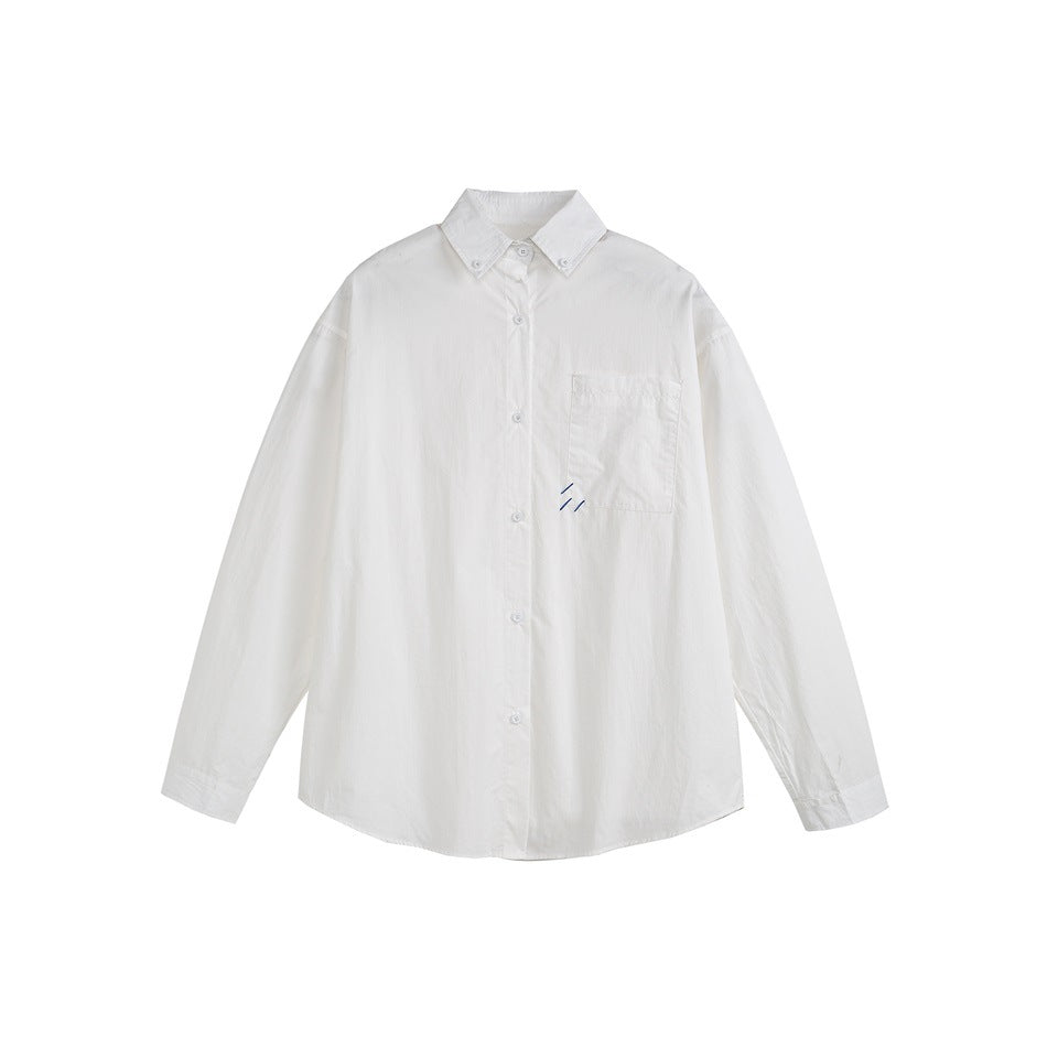 White long-sleeve button-down shirt flat lay with chest pocket and small blue stitched slash mark