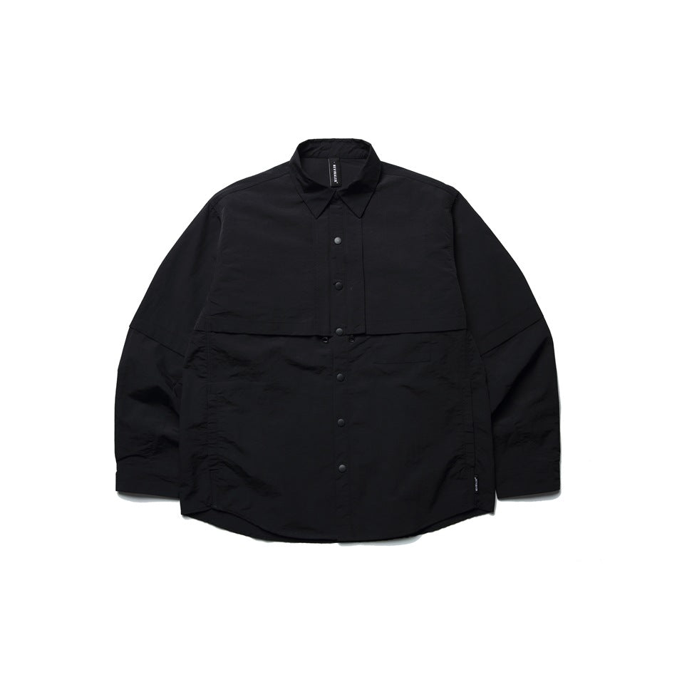 Black long-sleeve snap-front shirt jacket with layered chest panel and curved hem, flat lay on white