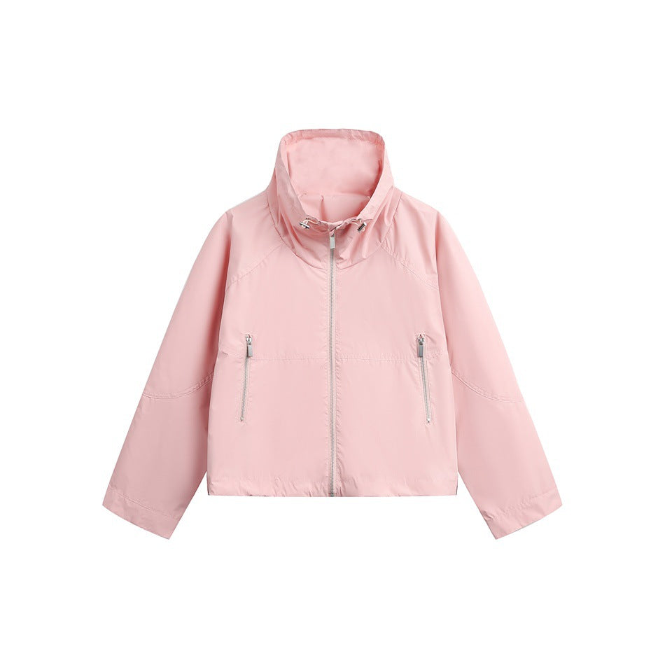 Pink cropped zip-up jacket with high drawcord collar and two zippered front pockets, flat lay on white