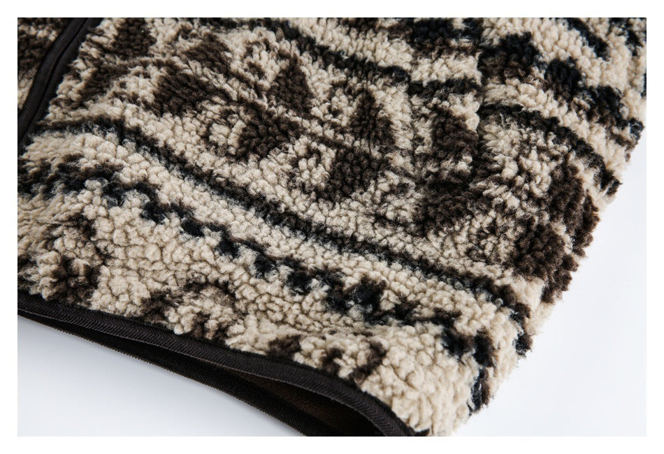 Close-up of the black-trimmed edge and plush patterned fleece, with part of a zipper visible.