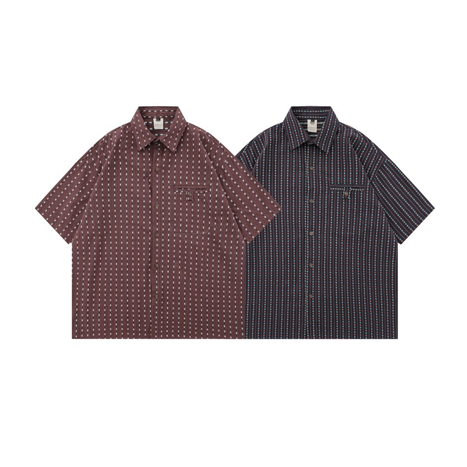 Two short-sleeve button-up shirts shown flat: one burgundy with pale motifs and one dark with turquoise and rust stripes.