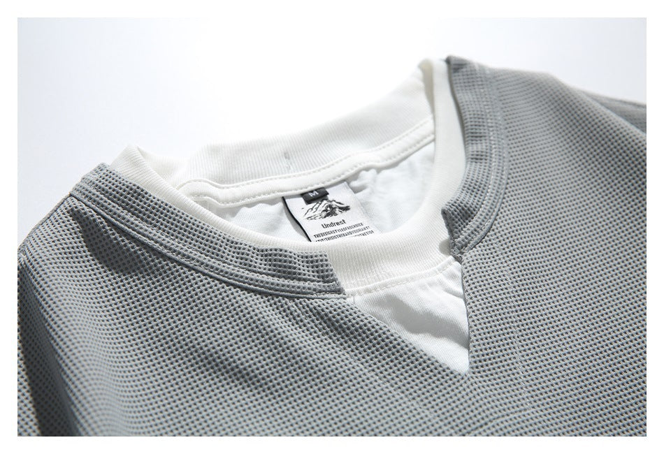 Close-up of the gray top's notched neckline, stitching, and white inner layer.