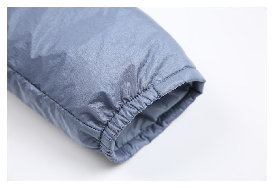 Close-up of a blue-gray sleeve opening with a gathered elastic cuff and visible lining.