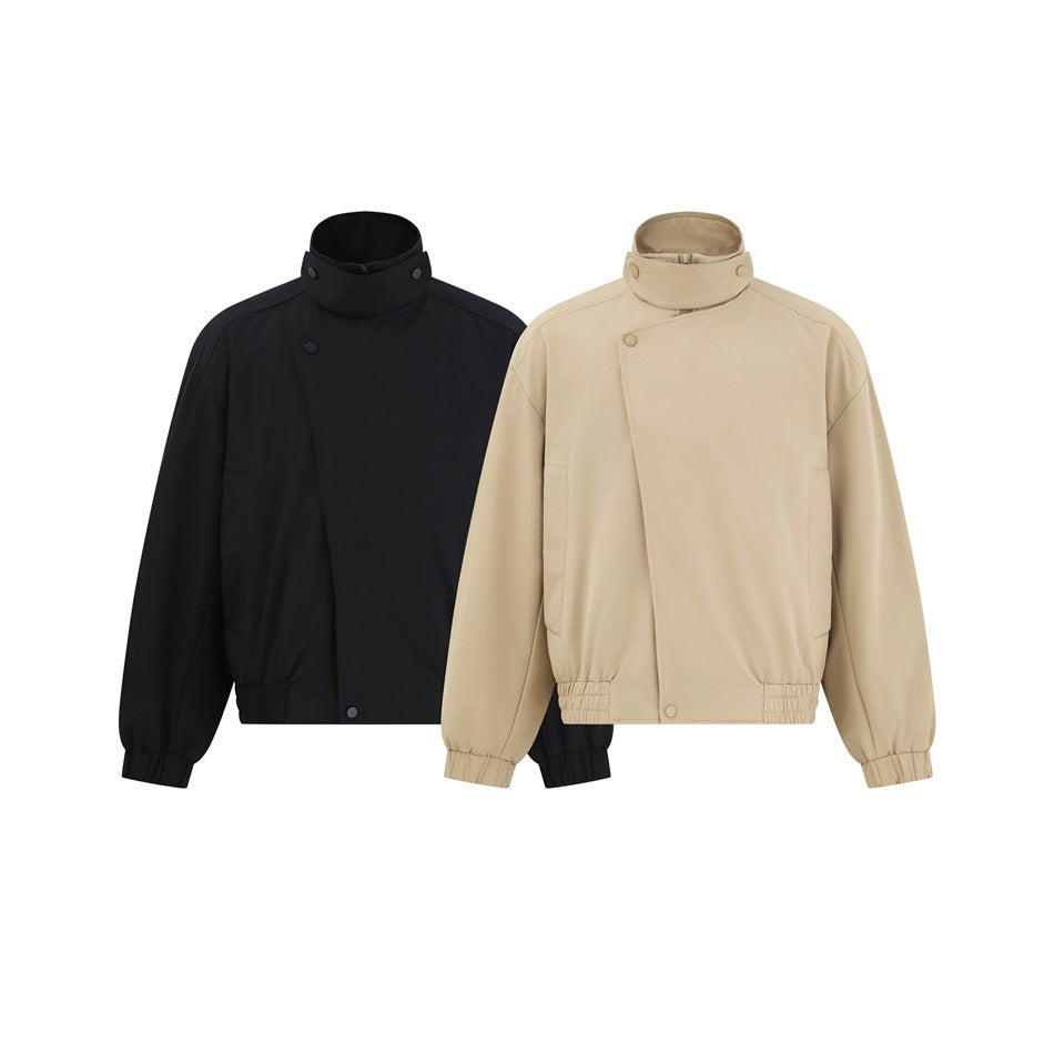 Beige and black versions of a high-collar jacket with asymmetrical snap closures and gathered cuffs and hems.