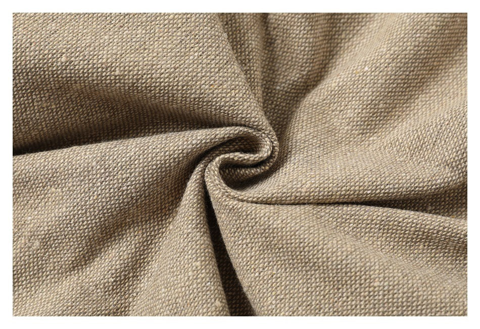 Close-up of beige and taupe woven fabric gathered into soft folds.