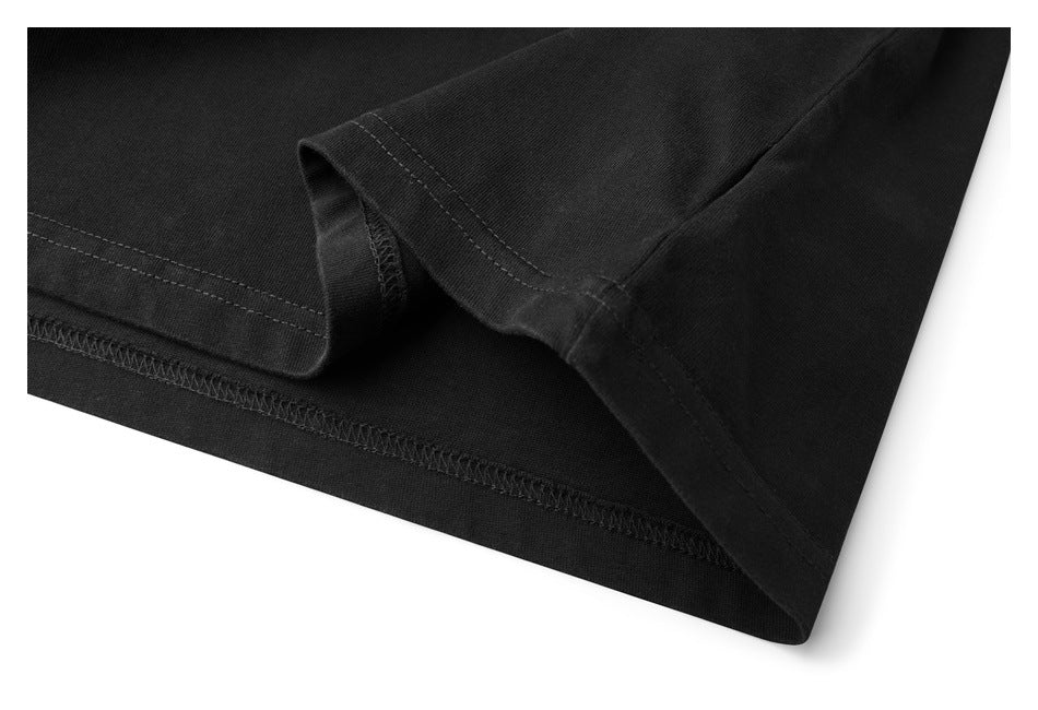Close-up of a black garment hem with visible double stitching and overlock seams.