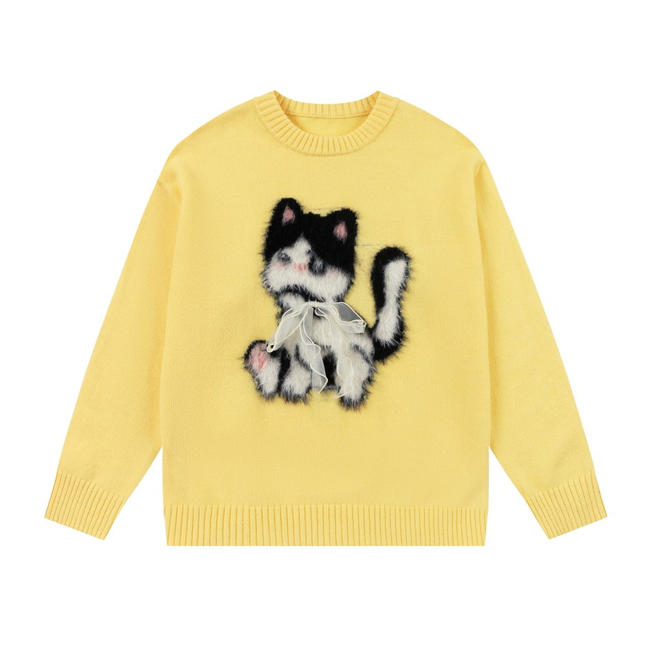 Yellow crew-neck knit sweater with fuzzy black and white cat motif and sheer ribbon bow, flat front view