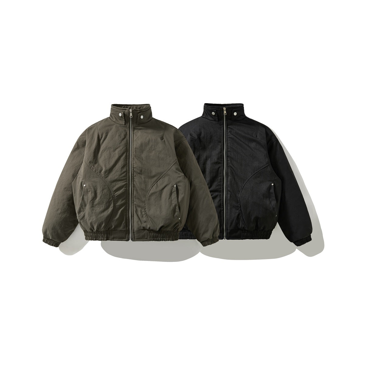 Front views of two stand-collar zip jackets with snap details and gathered hems, in olive gray and black.