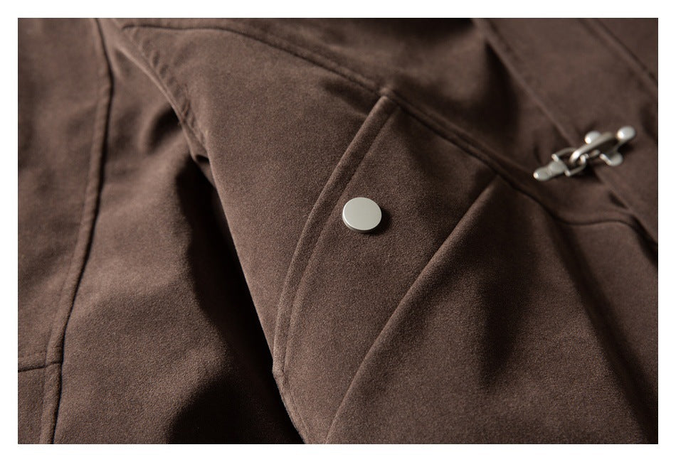 Close-up of a brown coat pocket, snap, and metal clasp.